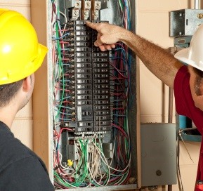 Electrical Inspection Services | Inspector looking at electrics